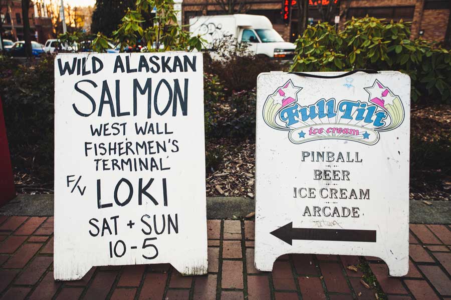 Sidewalk signs for Loki and Full Tilt Ice Cream.