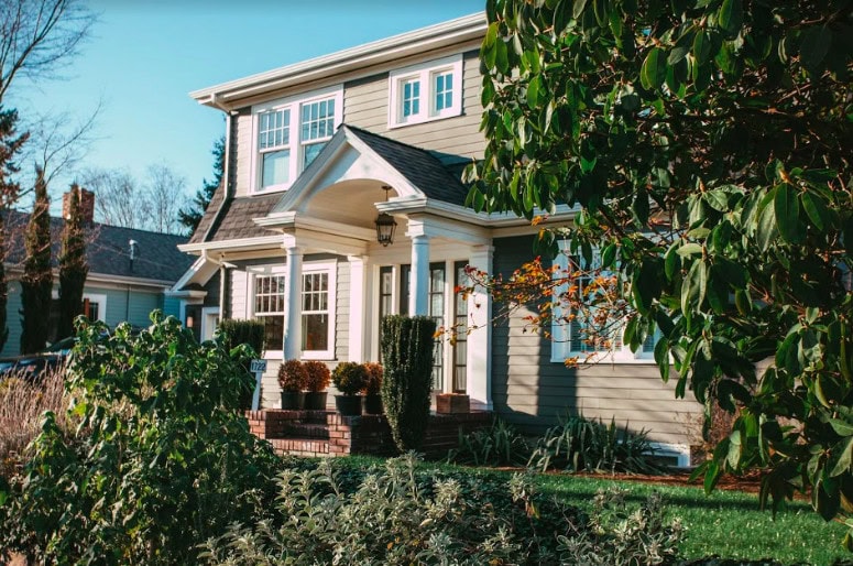 front view of nice two story home with trees on either side
