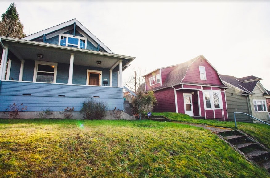 two homes with a large green yard in columbia city seattle