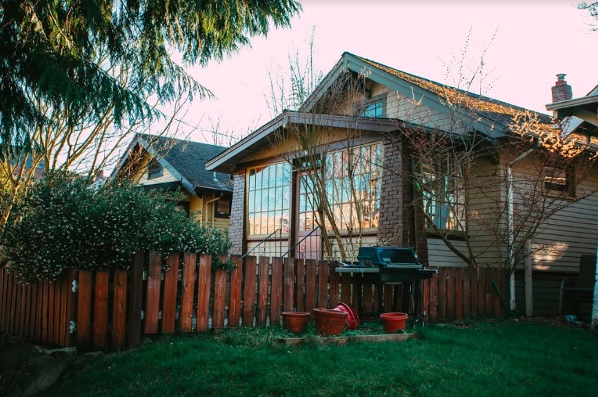 house and backyard with bbq and fence