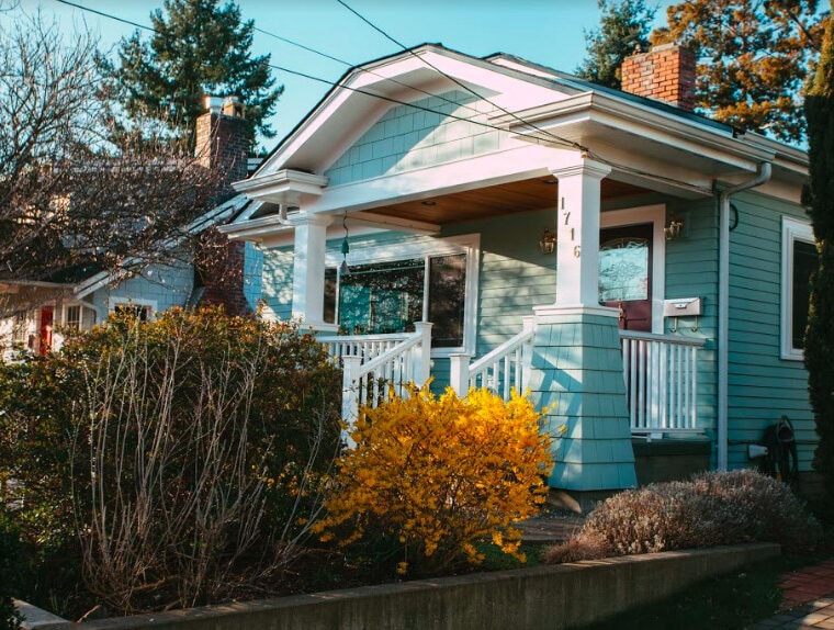 light blue beautiful house with a porch