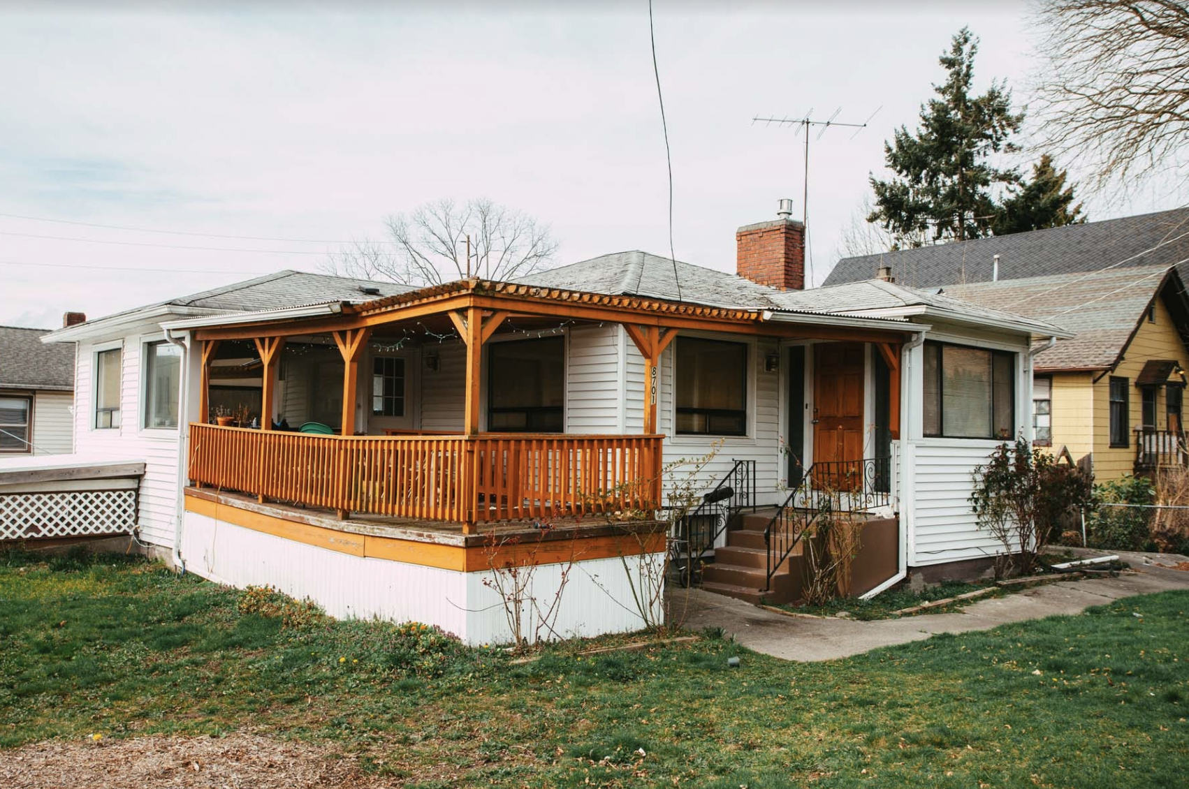 photo of house with a wraparound porch in a seattle neighborhood